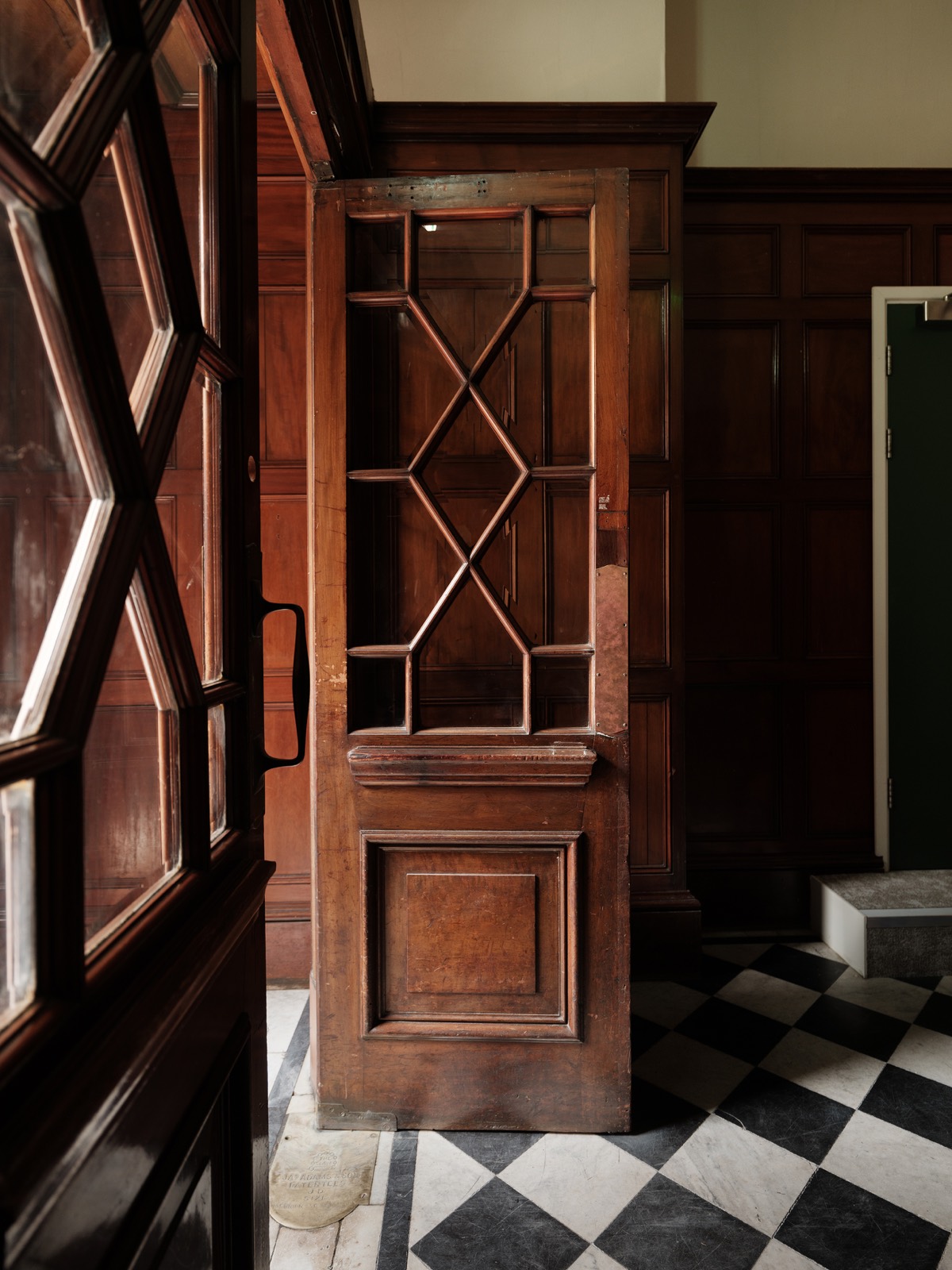 A heritage glazed door onto the chequered floor