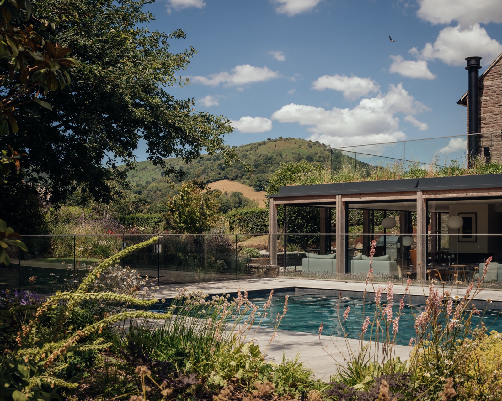 The pool and garden with the glazed, timber framed extension beyond