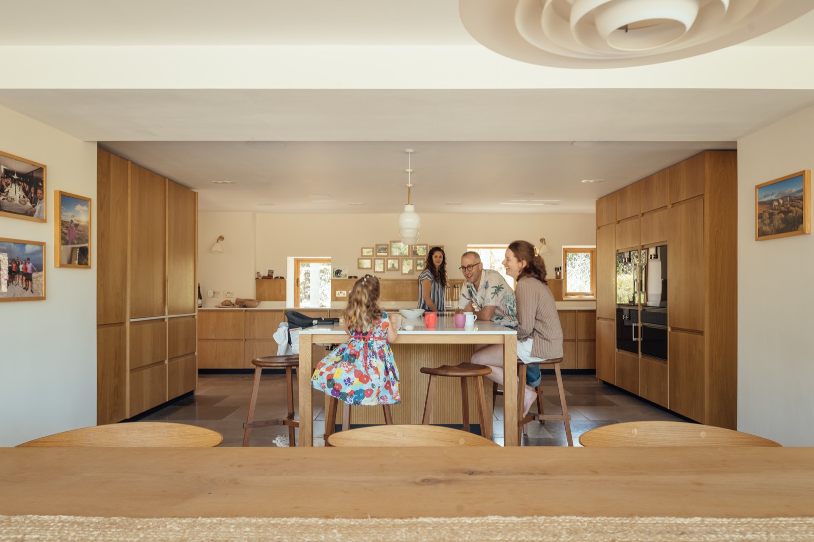 The kitchen with the family at the island