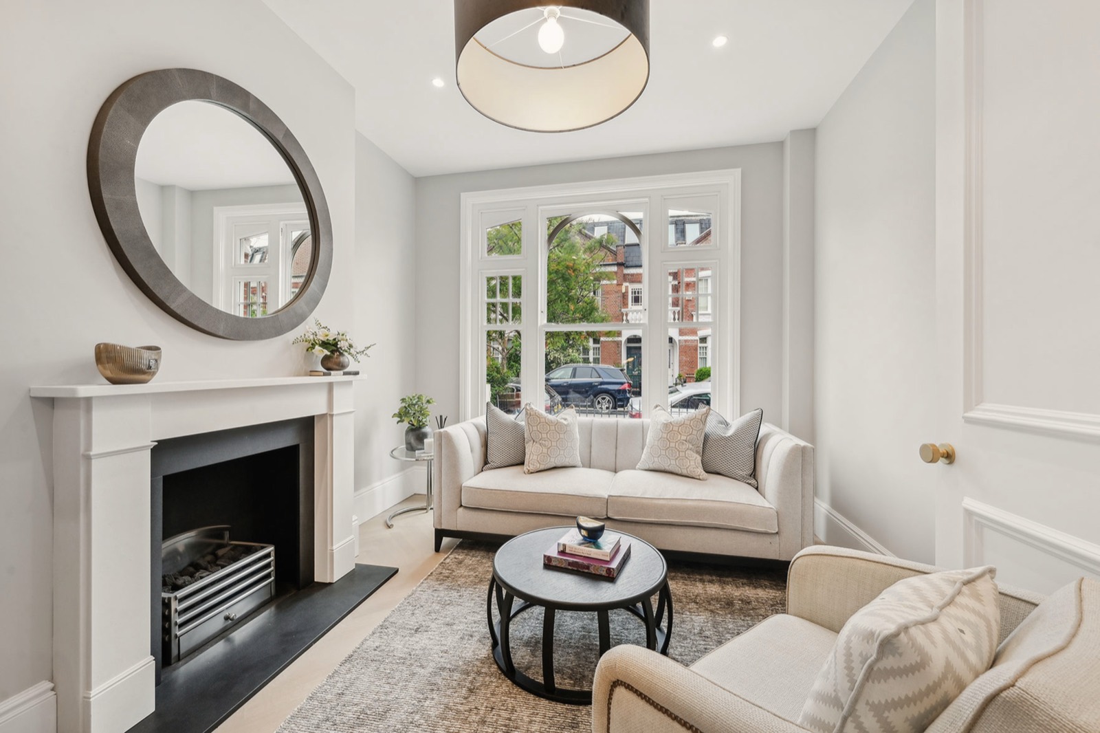 The front reception room, its fireplace and the window to the street
