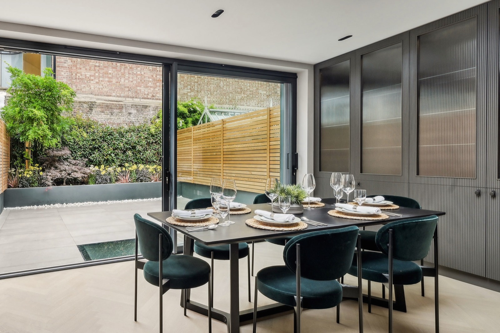 The dining table at the sliding doors, walk-on glass in the terrace beyond