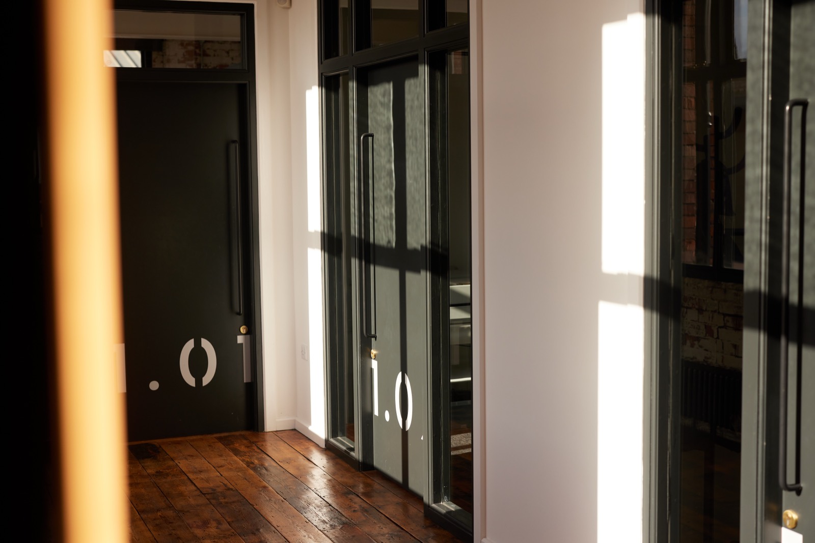 Glazed partitions and timber floors inside the workspace